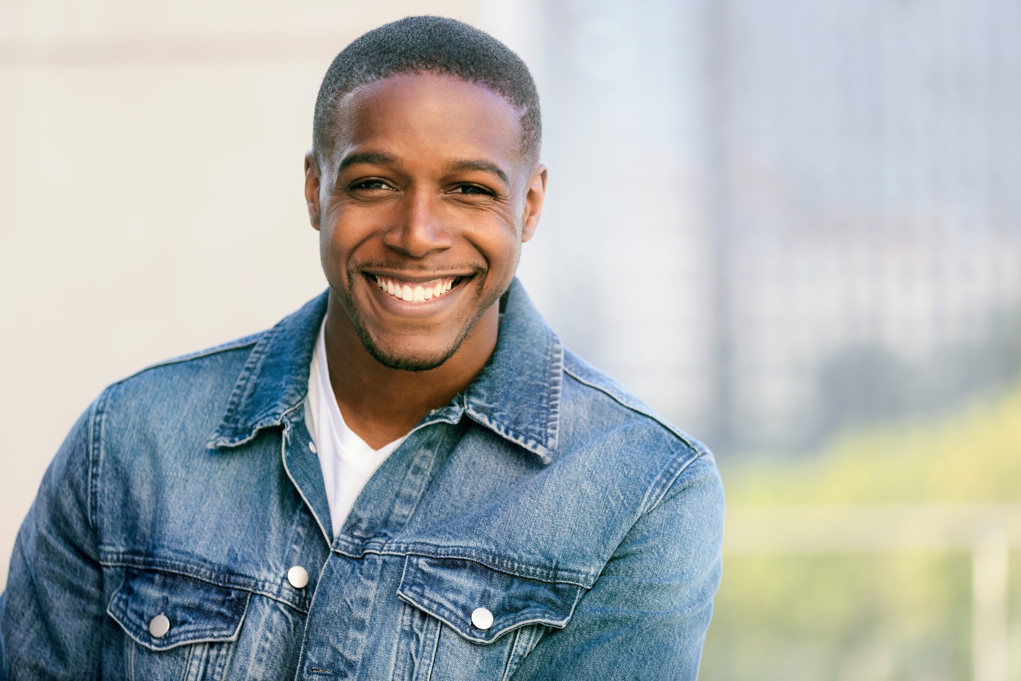 Close up head shot of a handsome commercial african american mod Periodontist near me